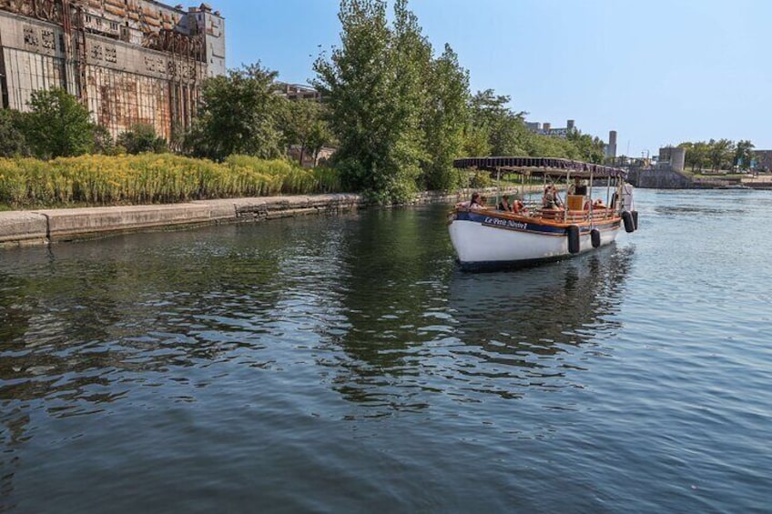 A boat on a river with a cityscape in the background. 3