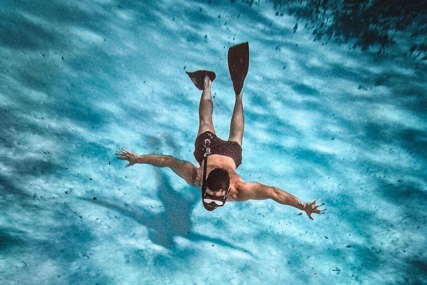 A person swimming underwater. 1