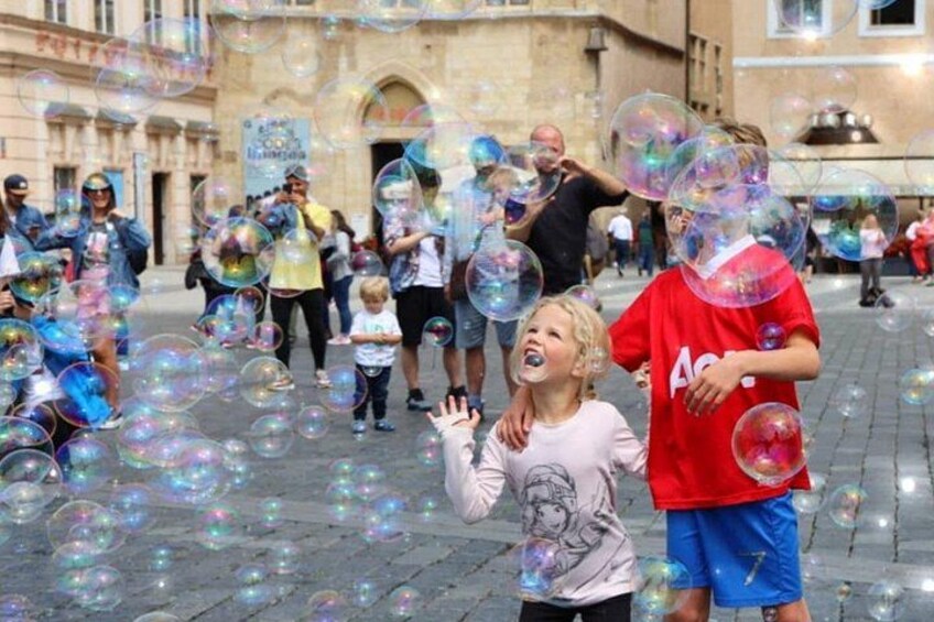 People playing with bubbles in an outdoor urban setting. 2