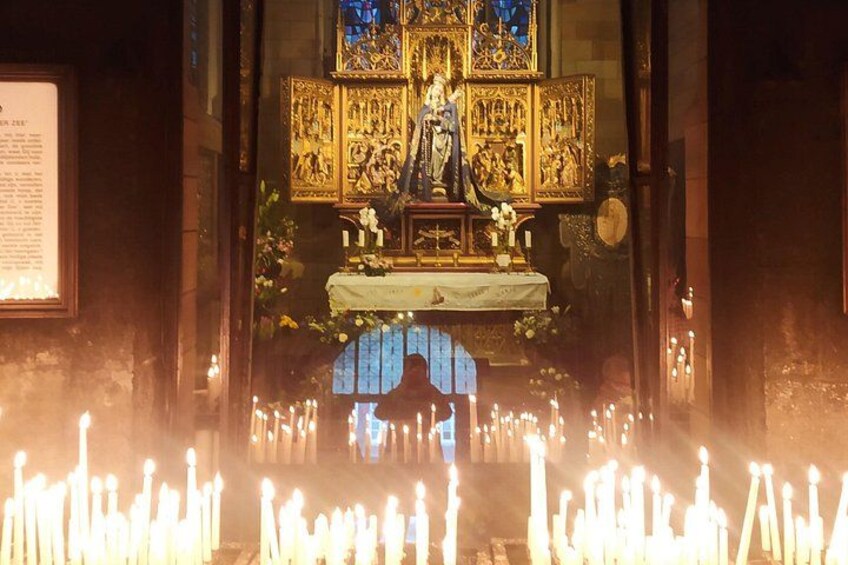 A religious altar with candles and religious icons. 2