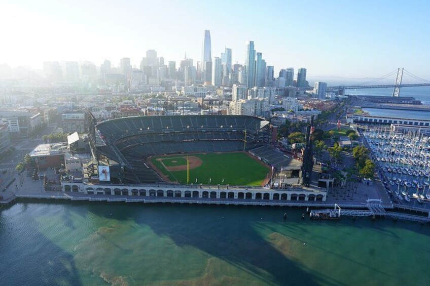 A baseball stadium with a city skyline in the background. 1