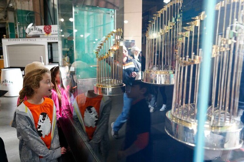 Children observing a display of trophies in a museum. 3