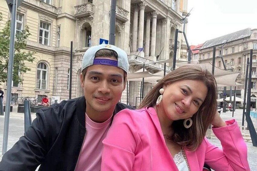 A person in a black jacket and a cap, and another in a pink jacket. 1