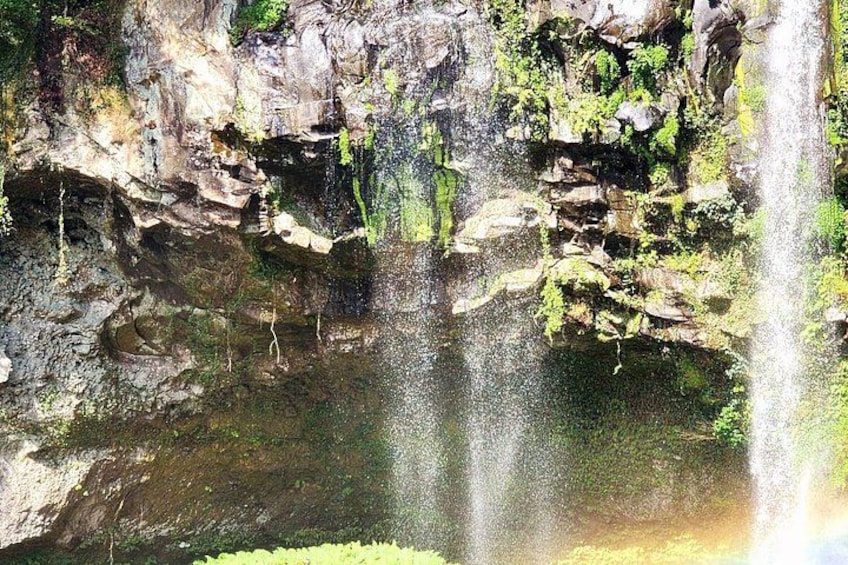 A waterfall cascading over rocky cliffs into a pool below. 4
