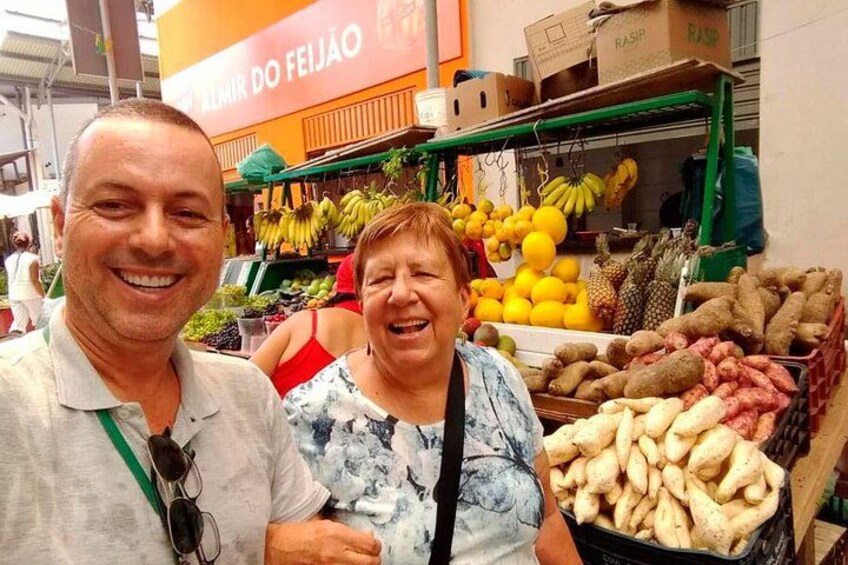 A market stall with bananas, pineapples, and other fruits. 2