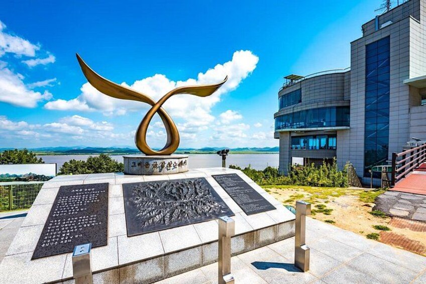A modern building with a unique sculpture in front. 5