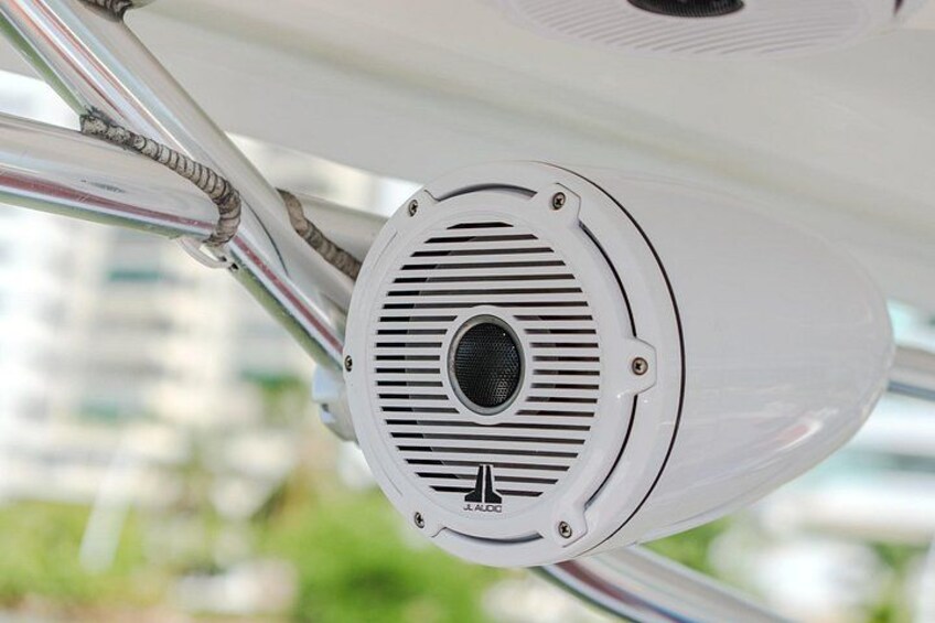 A white cylindrical object with a circular vent and a small logo at the bottom. 5