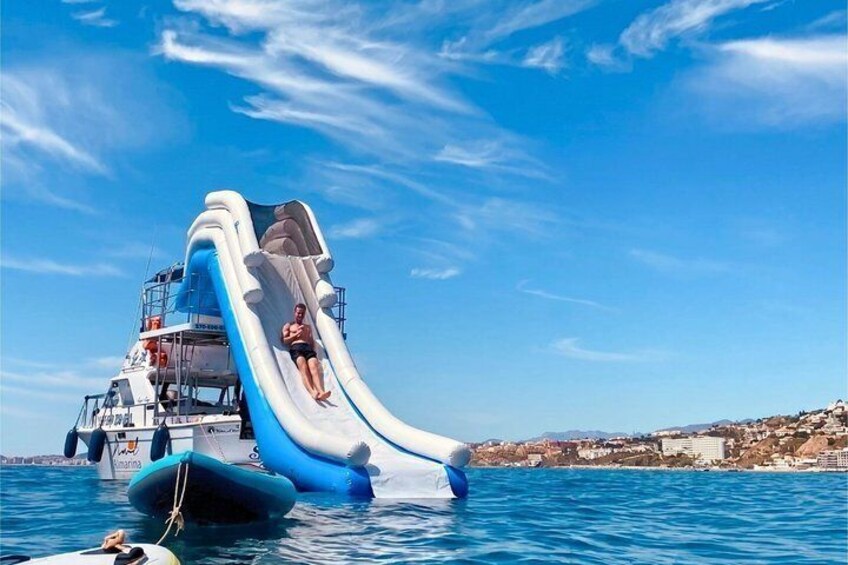 A water slide on a boat with a person sliding down. 1