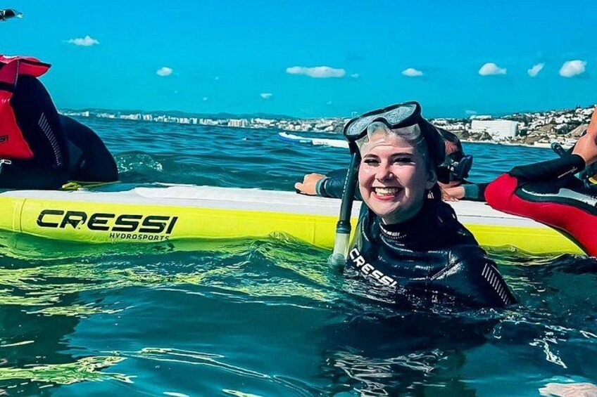 A person in a wetsuit on a yellow Cressi hydro sports board in the water. 3