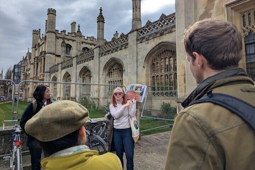A group of people standing in front of a historic building with large windows and intricate architectural details. 3