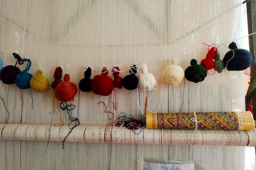 A skein of yarn hanging on a wooden surface. 2