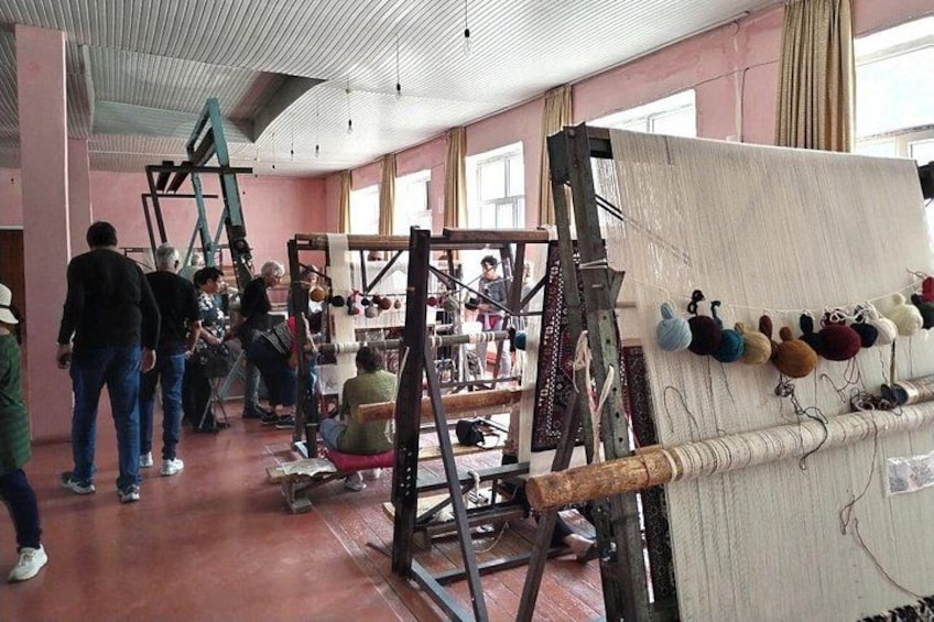 A textile workshop with weaving looms and colorful yarns. 3