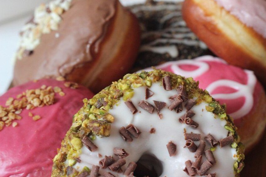 A variety of donuts with different toppings and colors. 4