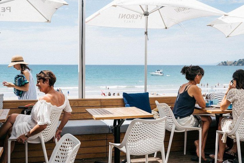 A beachside cafe with outdoor seating and umbrellas. 5