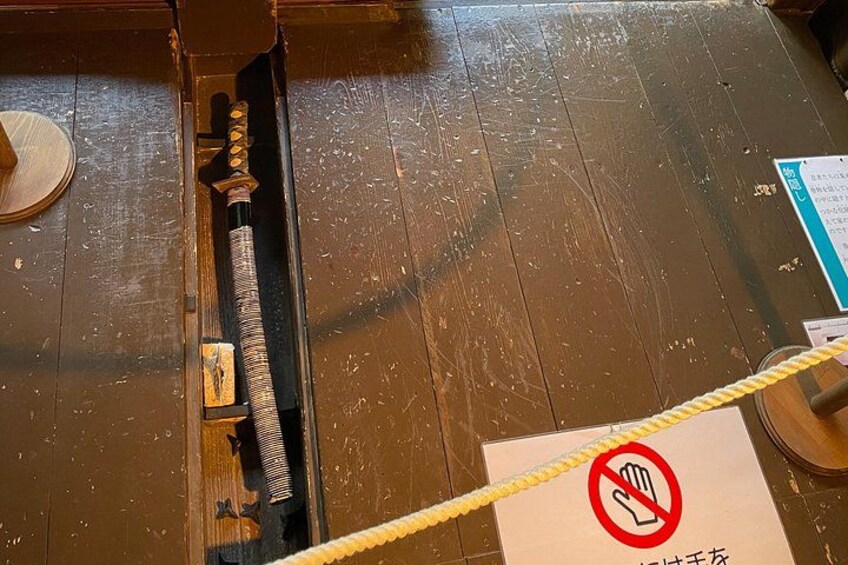 A wooden floor with a rope barrier and a no-touch sign. 2