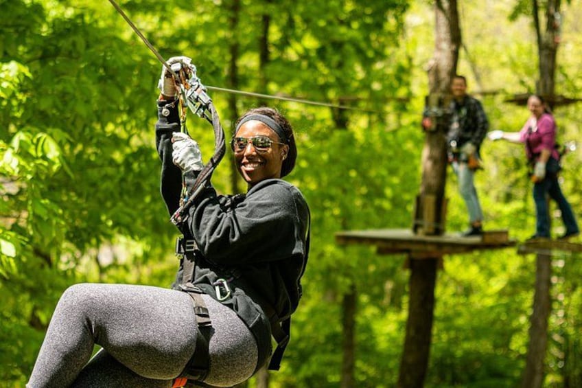 An individual zip-lining through a forest. 2