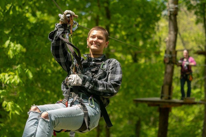 A person zip-lining through a forest. 5