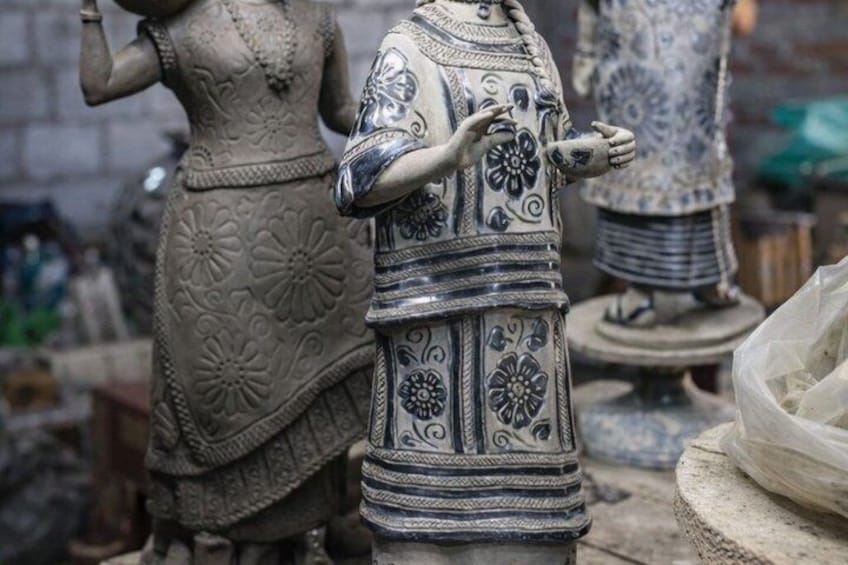 Ceramic statues with intricate floral patterns and a blue and white color scheme. 2