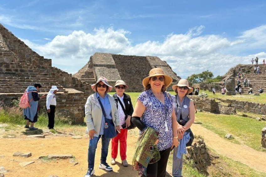 Tourists at an ancient archaeological site with pyramids and ruins. 1