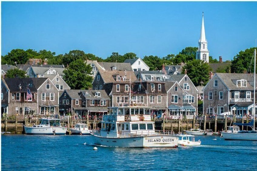 A harbor with boats, a church, and houses along the waterfront. 3