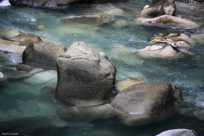 A clear stream with large rocks. 5