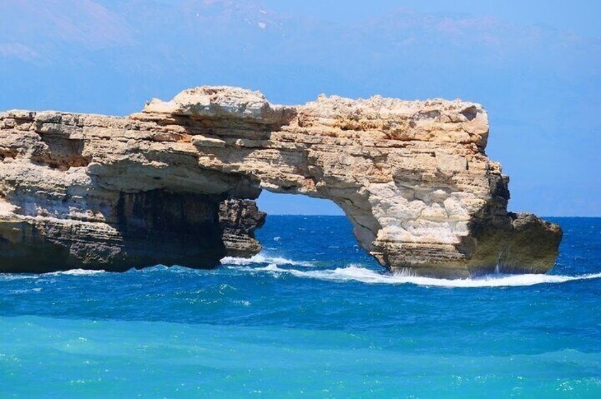 A natural rock arch formation in the ocean. 1