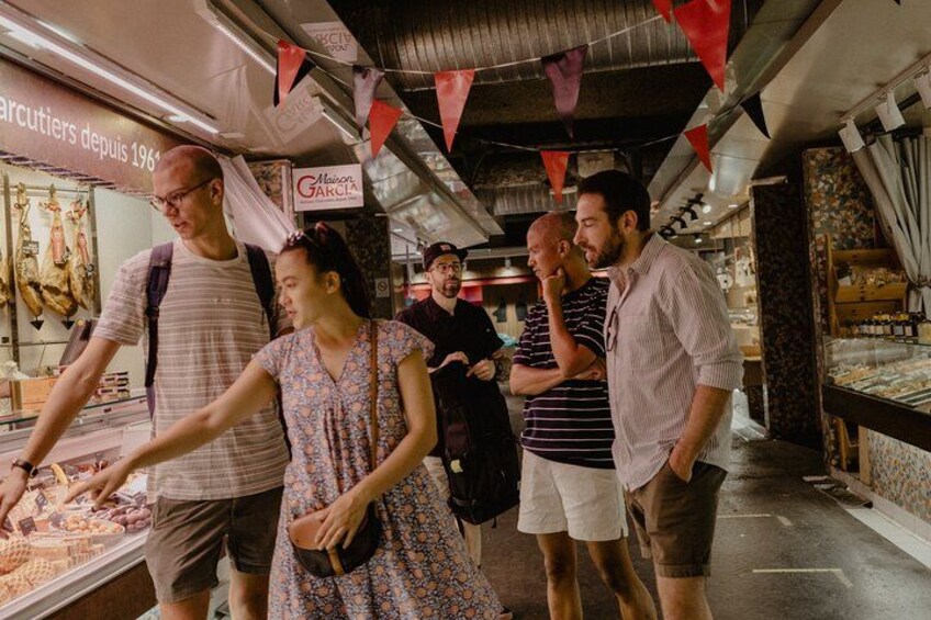 A market with people browsing and selecting items. 2