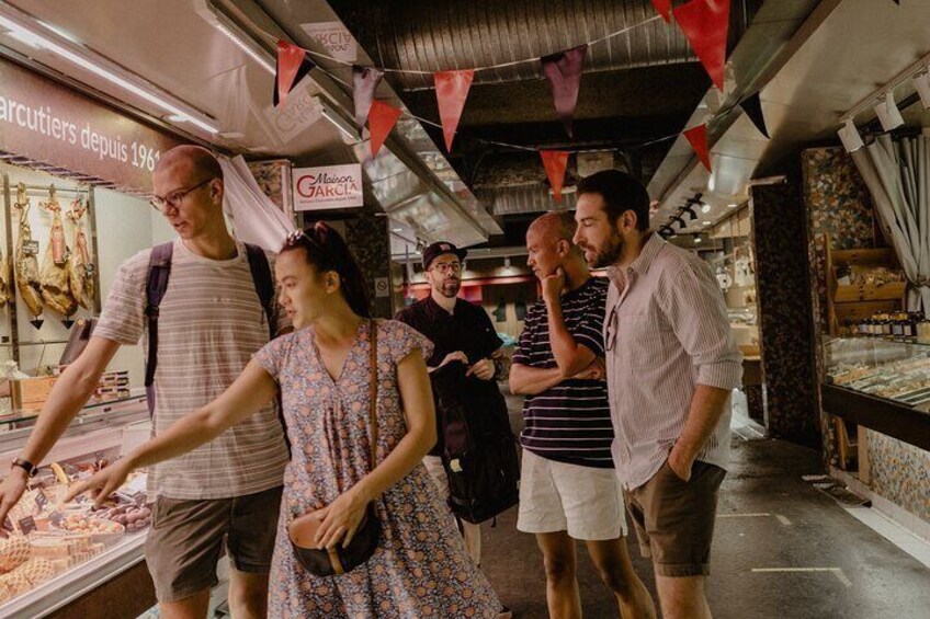 People browsing food items in a market. 2
