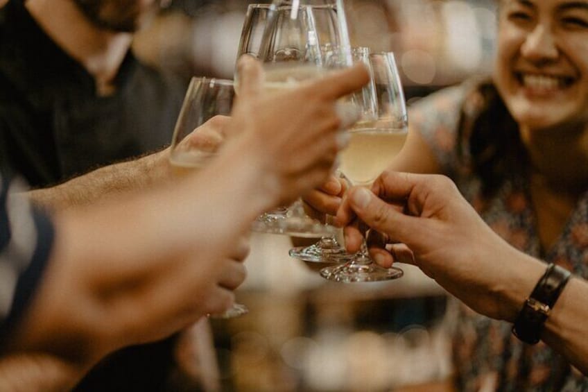 A group of people toasting with wine glasses. 4