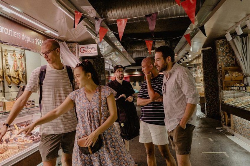 A market with people browsing and interacting with vendors. 2