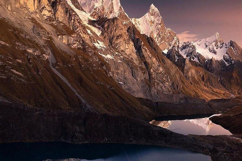 A mountainous landscape with a lake and snow-capped peaks. 3