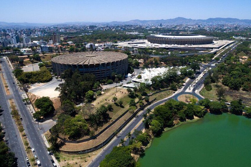 A stadium surrounded by roads, greenery, and a body of water. 4