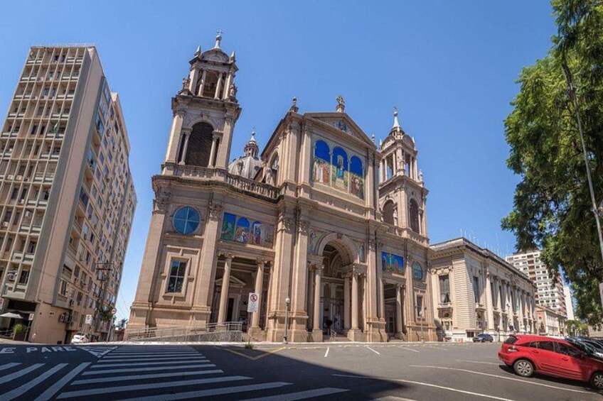 A historic building with a clock tower and large windows. 2