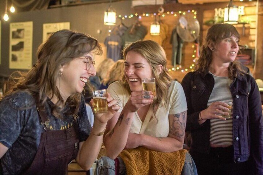 Människor skålar med drinkar i en bar med en varm och behaglig belysning. 5