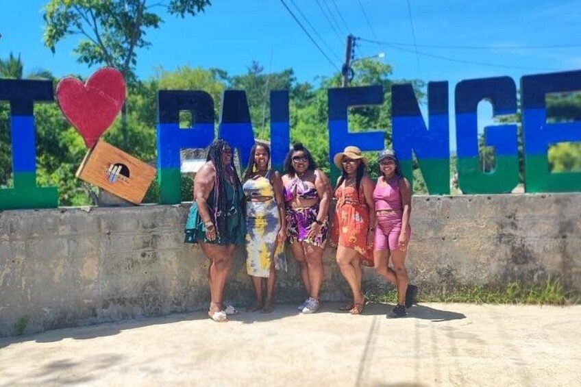A group of people standing in front of a sign with the text 'I ♥ BALANCE' and a heart-shaped object. 3