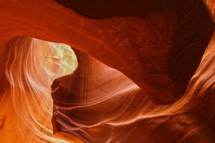 A canyon with smooth, curved rock formations and a narrow opening. 1