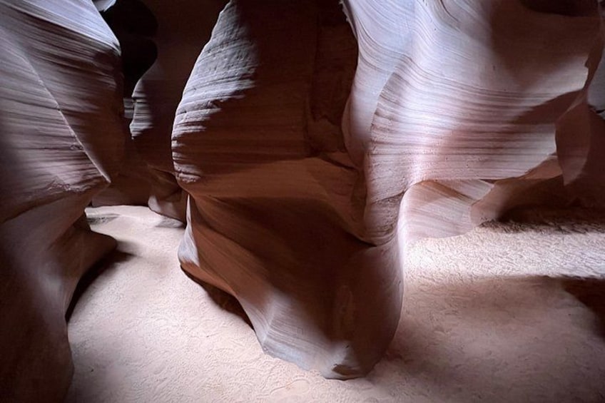 A canyon with smooth, curved rock formations. 3