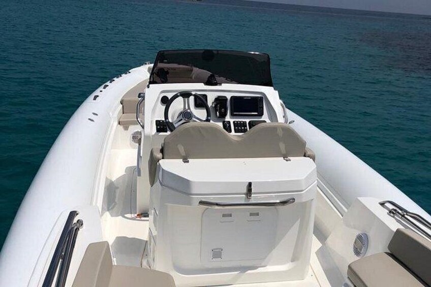A white motorboat on calm water. 4