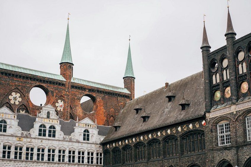 A historic building with a clock tower, arched windows, and a brick facade. 4