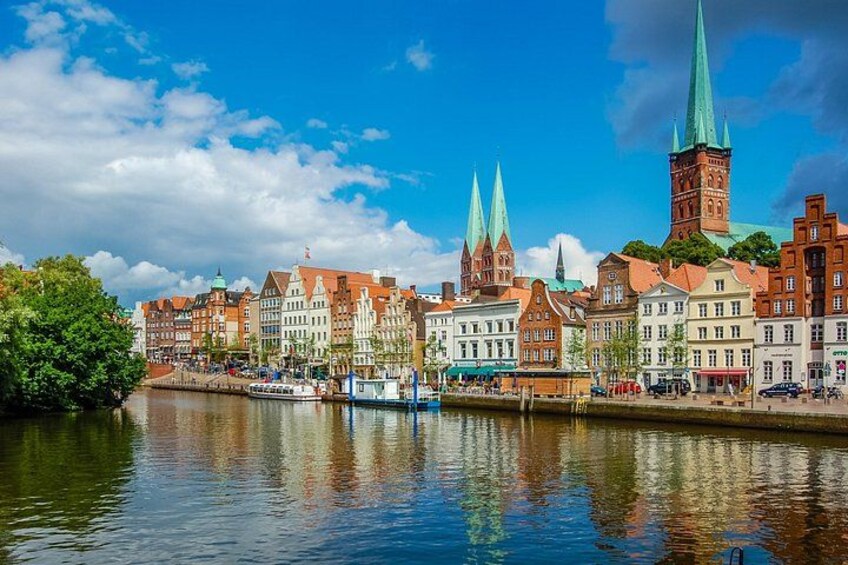 A river with buildings and a tower reflecting on the water. 5