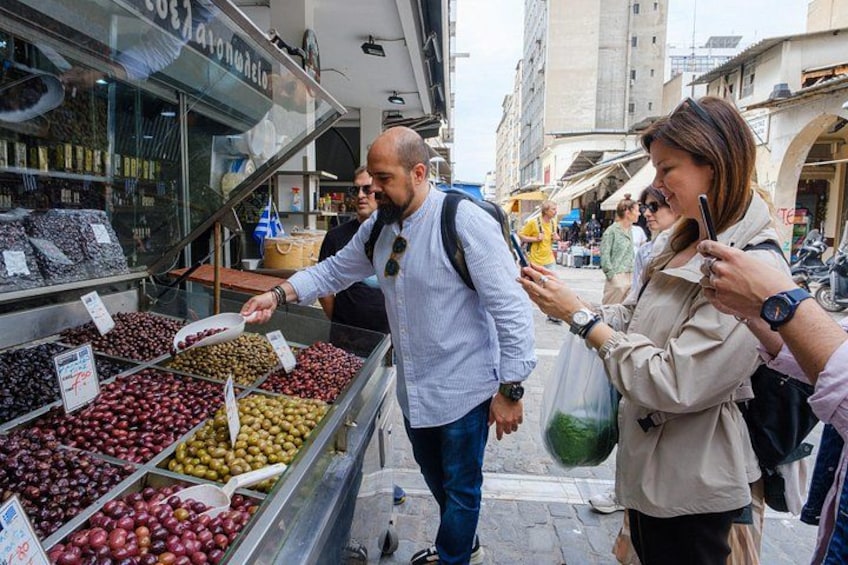 A street market with a vendor selling various fruits and vegetables. 2