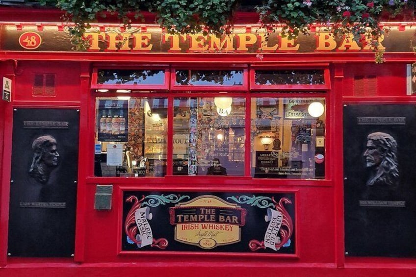 A red building with a sign that reads 'The Temple Bar.' 2