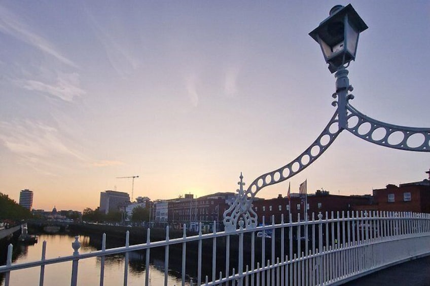 A bridge with ornate railings, a river, and buildings in the background. 5