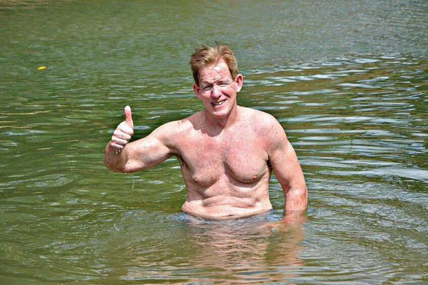 A person giving a thumbs-up gesture in a body of water. 5