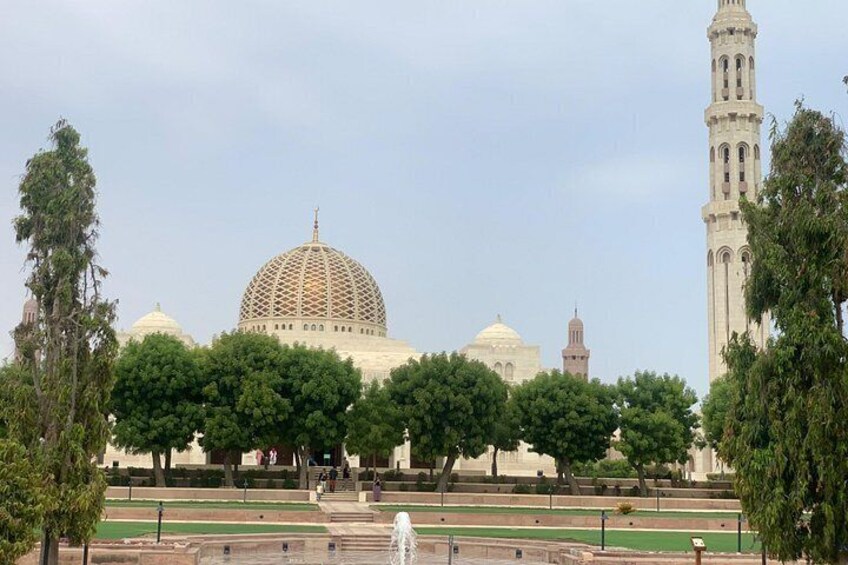 A large domed building with a minaret, surrounded by trees and a fountain. 2