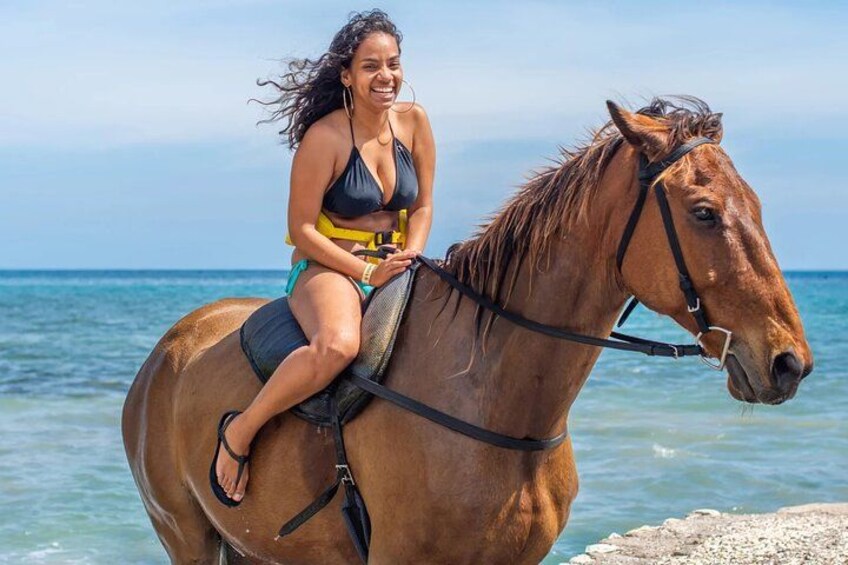 A person riding a horse by the sea. 2