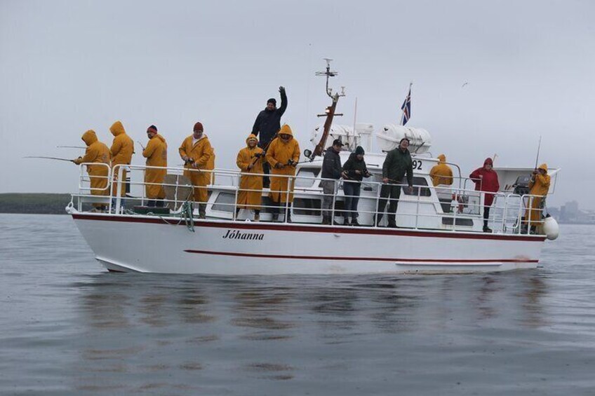 A boat named 'Johanna' with people in yellow rain gear on board. 2
