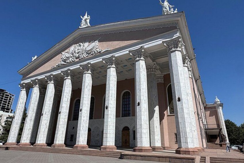 A classical building with columns, a pediment, and statues. 5