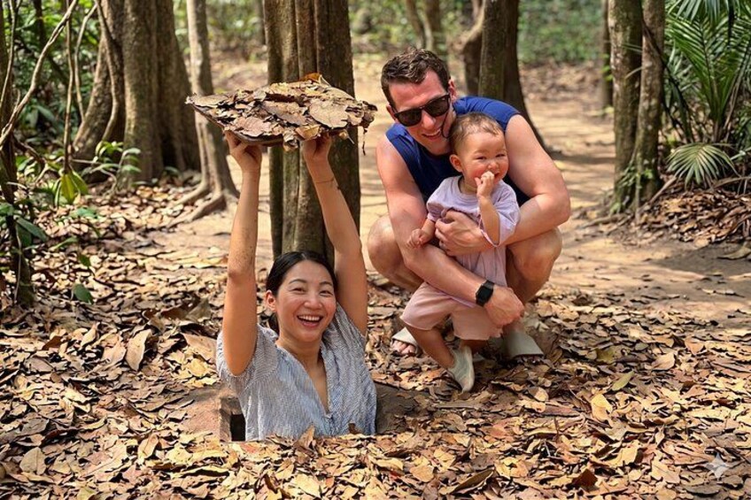 A family in a forest with a child holding a large piece of wood. 5