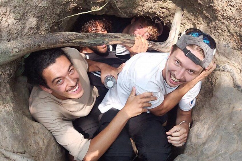 Two people inside a cave, one wearing a white shirt and the other a beige shirt. 4